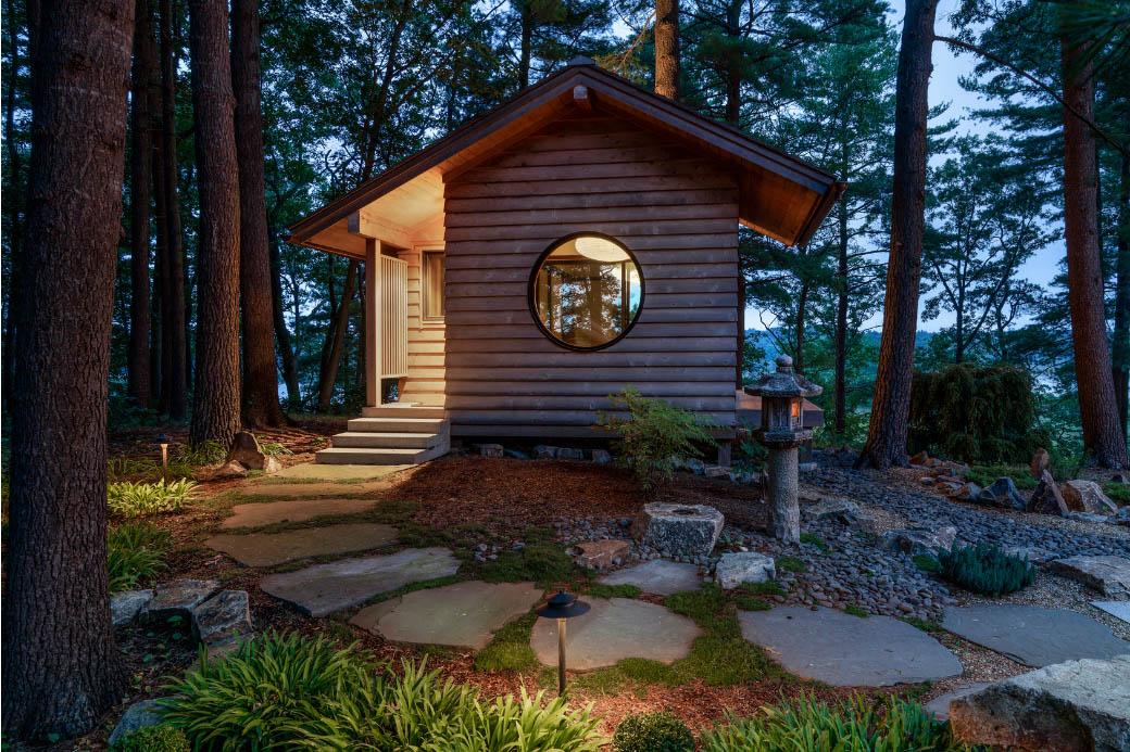 Wooden Japanese tea house in garden at night