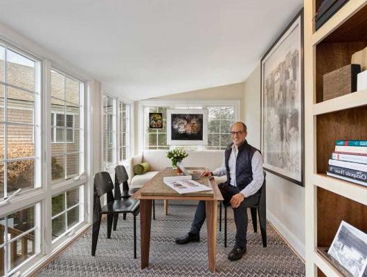 Nick Stanos sitting at a desk in his office